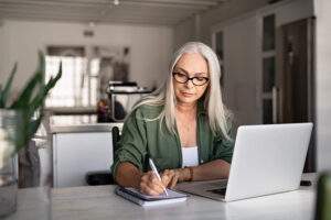 person writing on notepad